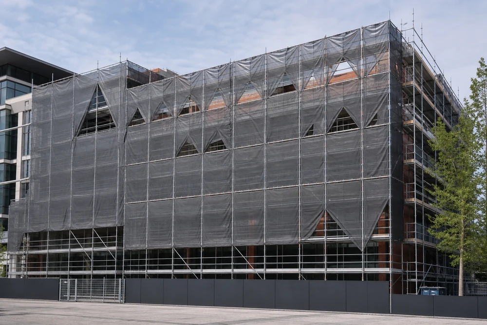scaffold tarps installed on a building facade for jobsite protection