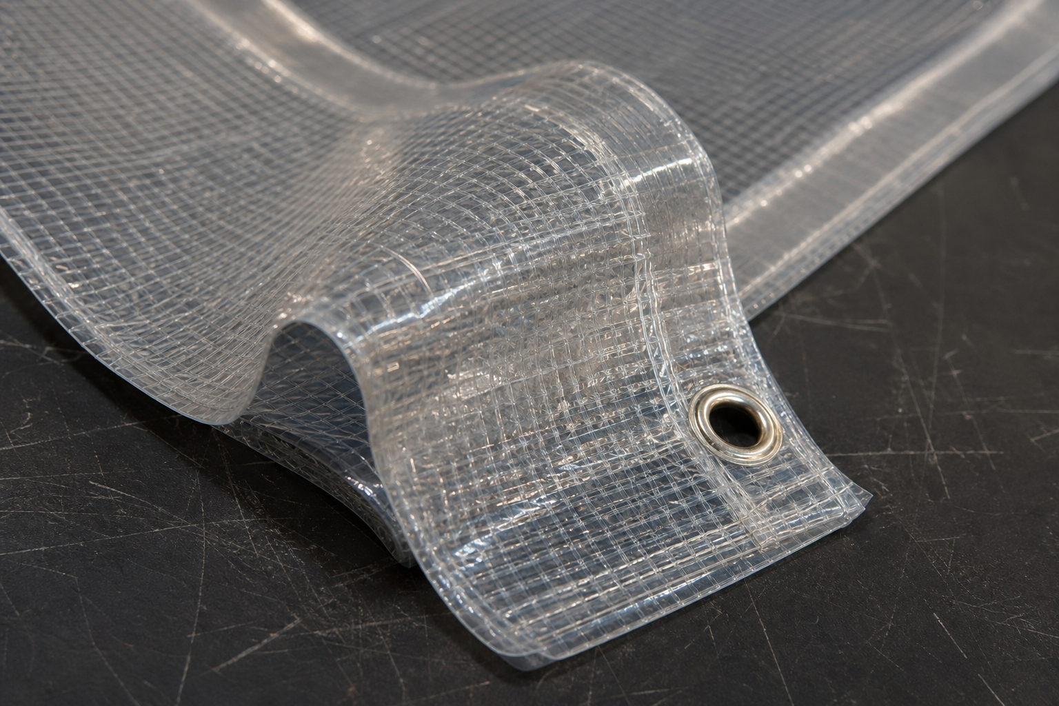 Transparent reinforced PVC tarp material with welded hem and thin realistic edge