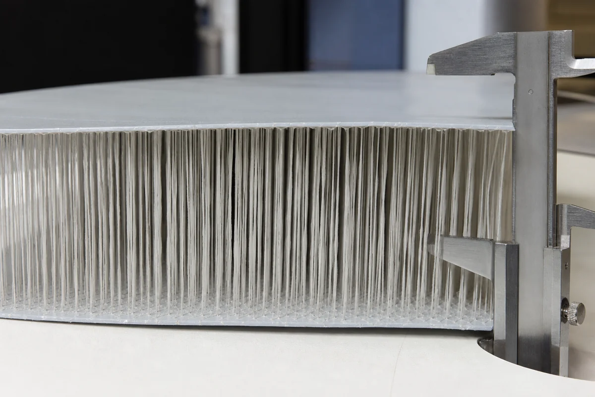 drop stitch core with dense connecting yarns holding two coated textile faces at a uniform height