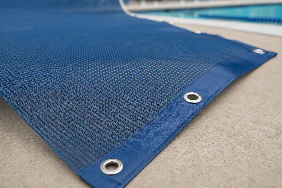 mesh pool cover material with reinforced edge and grommets