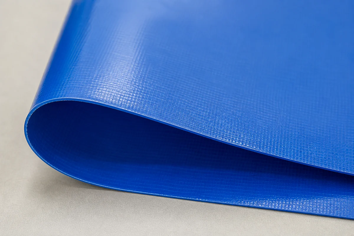 PVC coated polyester flatbed tarp material sample showing smooth coating and reinforced fabric structure