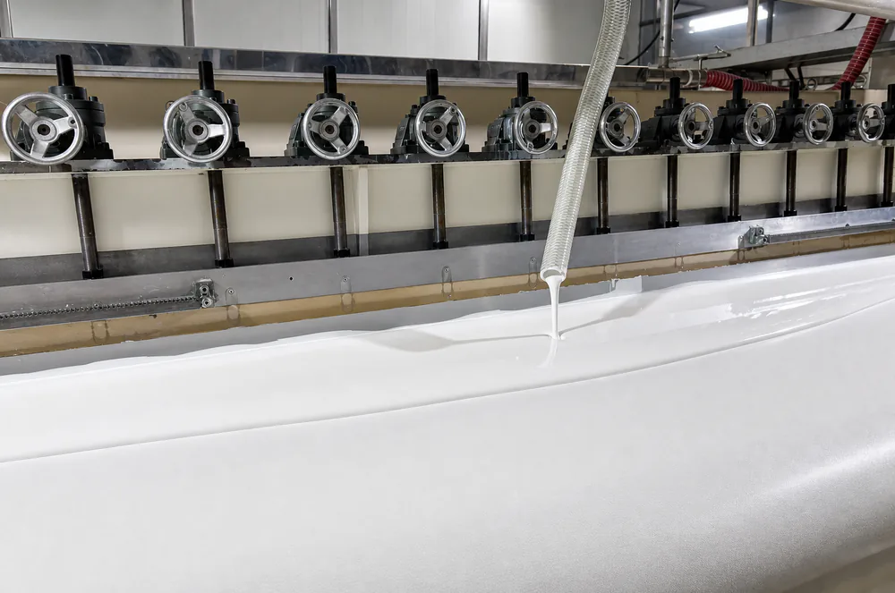 White waterproof fabric moving through LonaTarp's industrial coating line