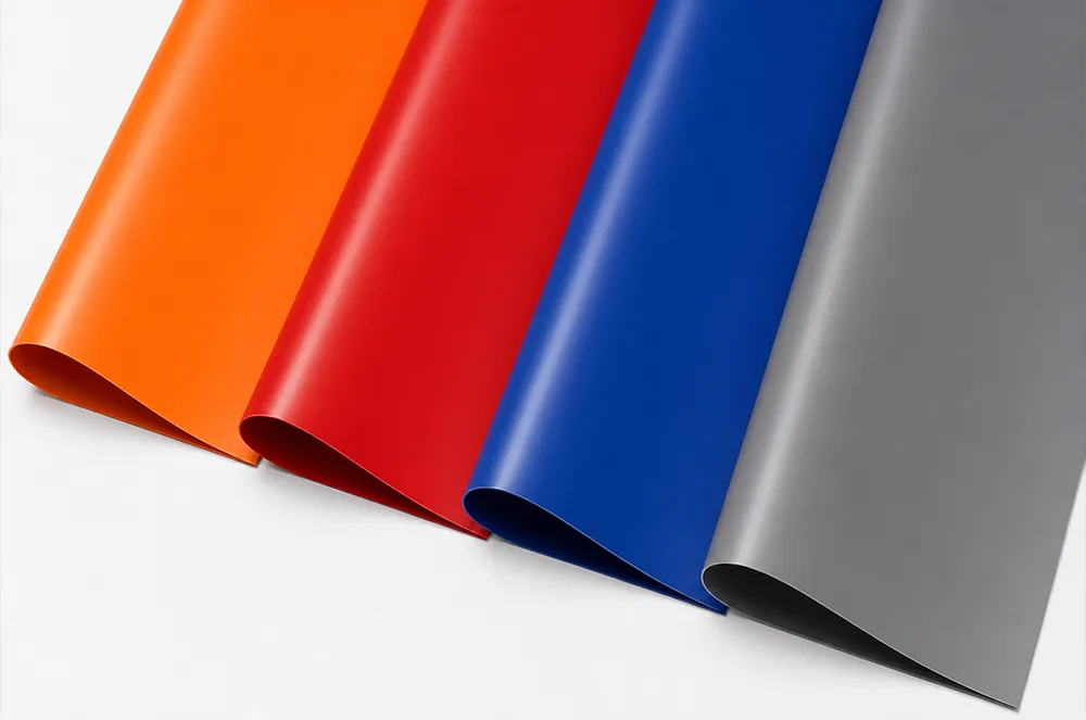 Flexible coated truck tarp material samples in orange, red, blue and gray
