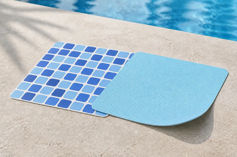 Blue and mosaic-pattern pool liner material samples beside a swimming pool