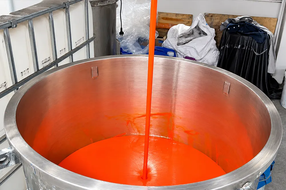 orange-coating-paste-pouring-into-vat